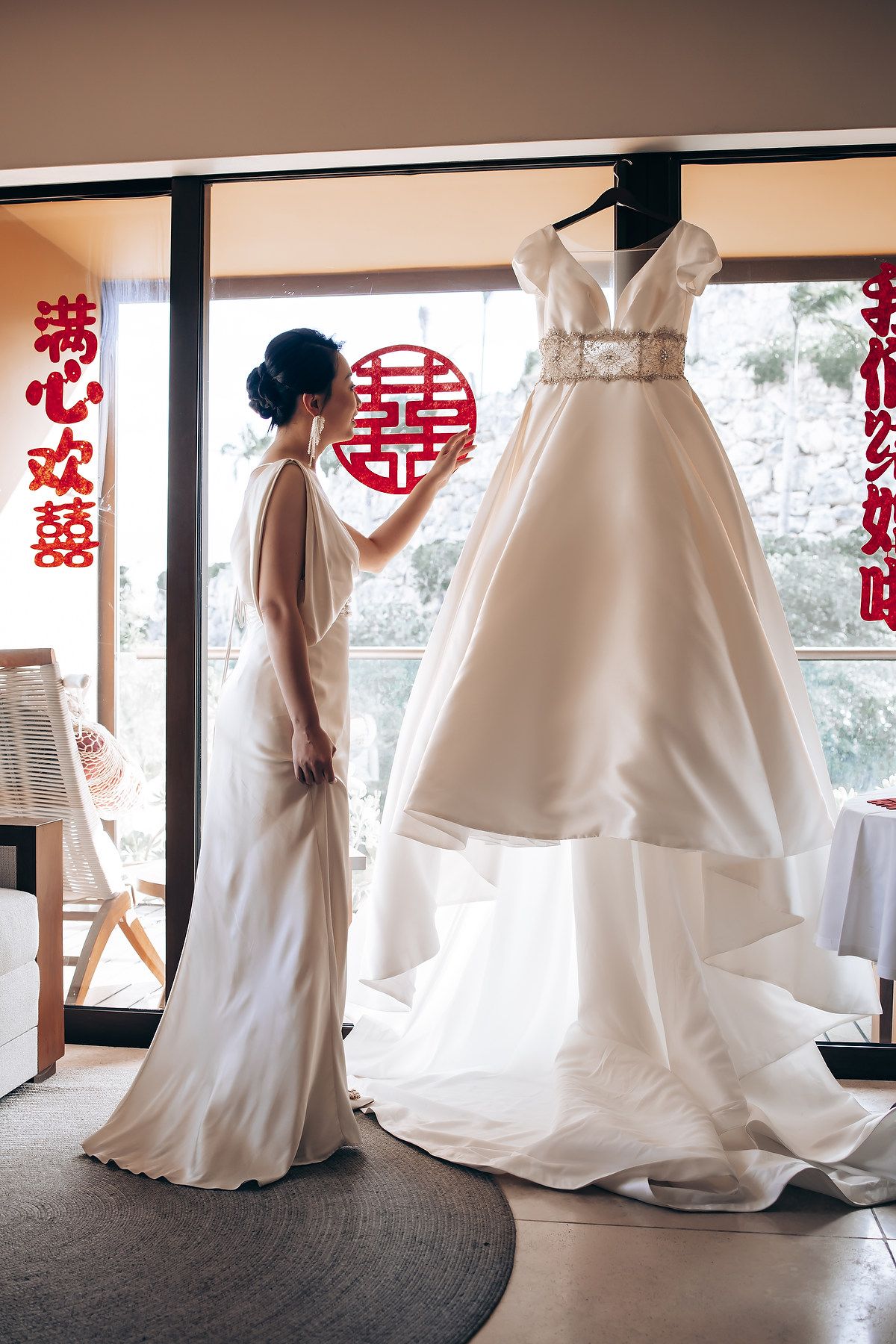 Wedding dress preparation sequence showing flowing white gowns against interior windows.