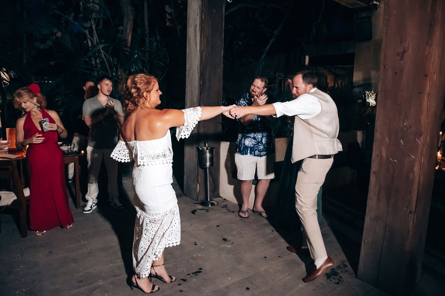 Dance floor filled with wedding guests celebrating at a reception.