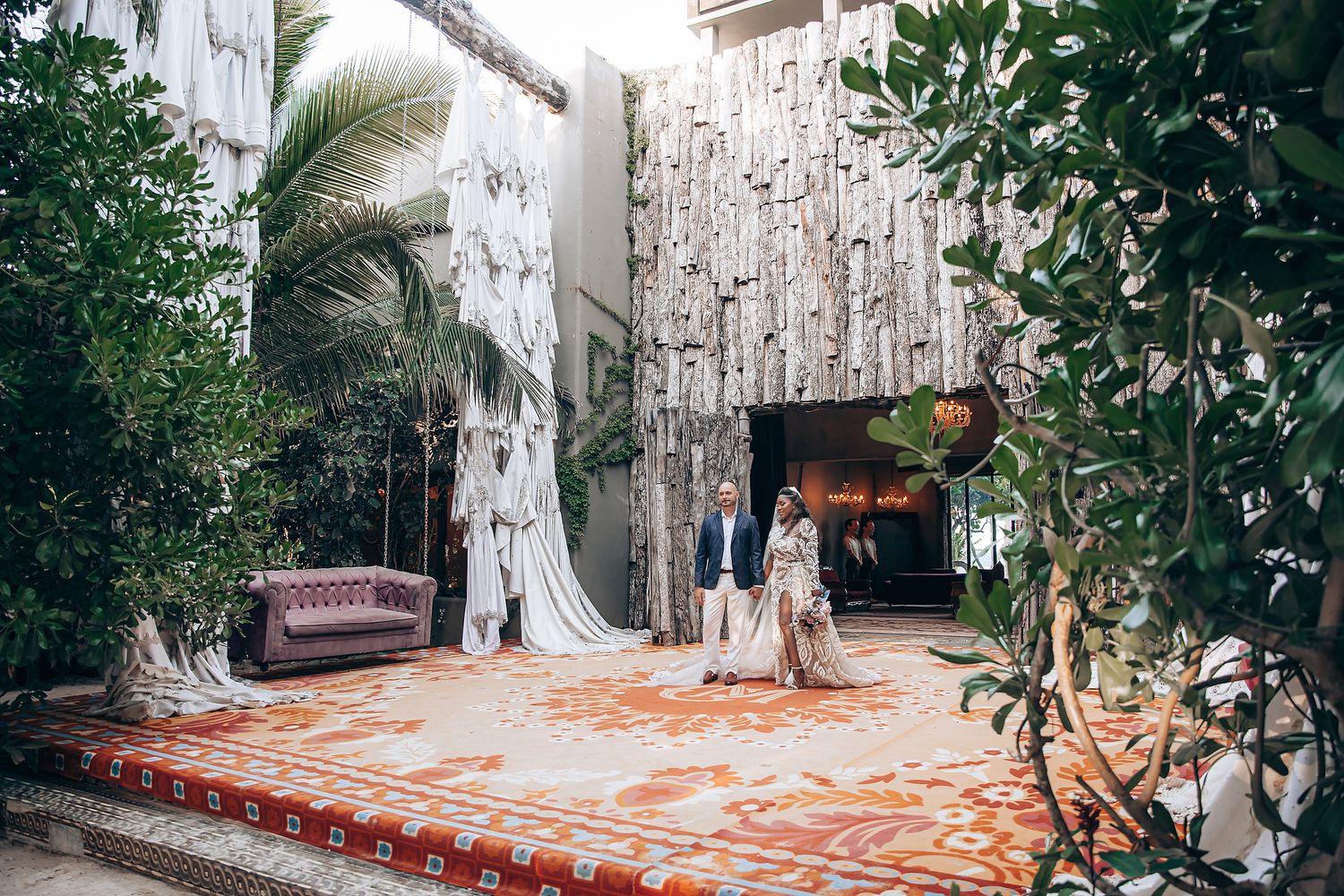 Rustic outdoor wedding venue pathway lined with white birch trees and natural foliage.