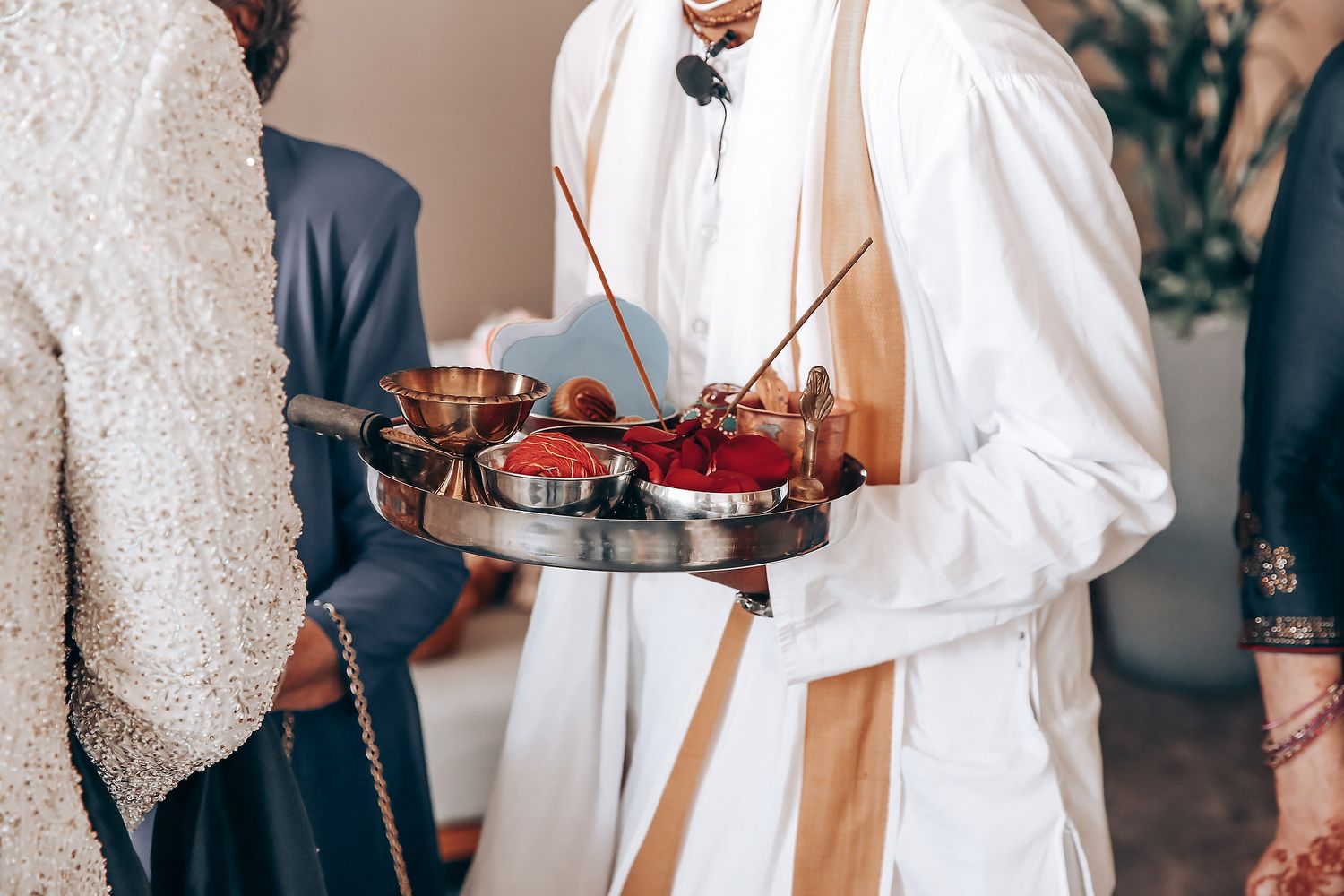 Collage of wedding photos showing elegant details of white dresses, bouquets, and formal attire at a celebration.