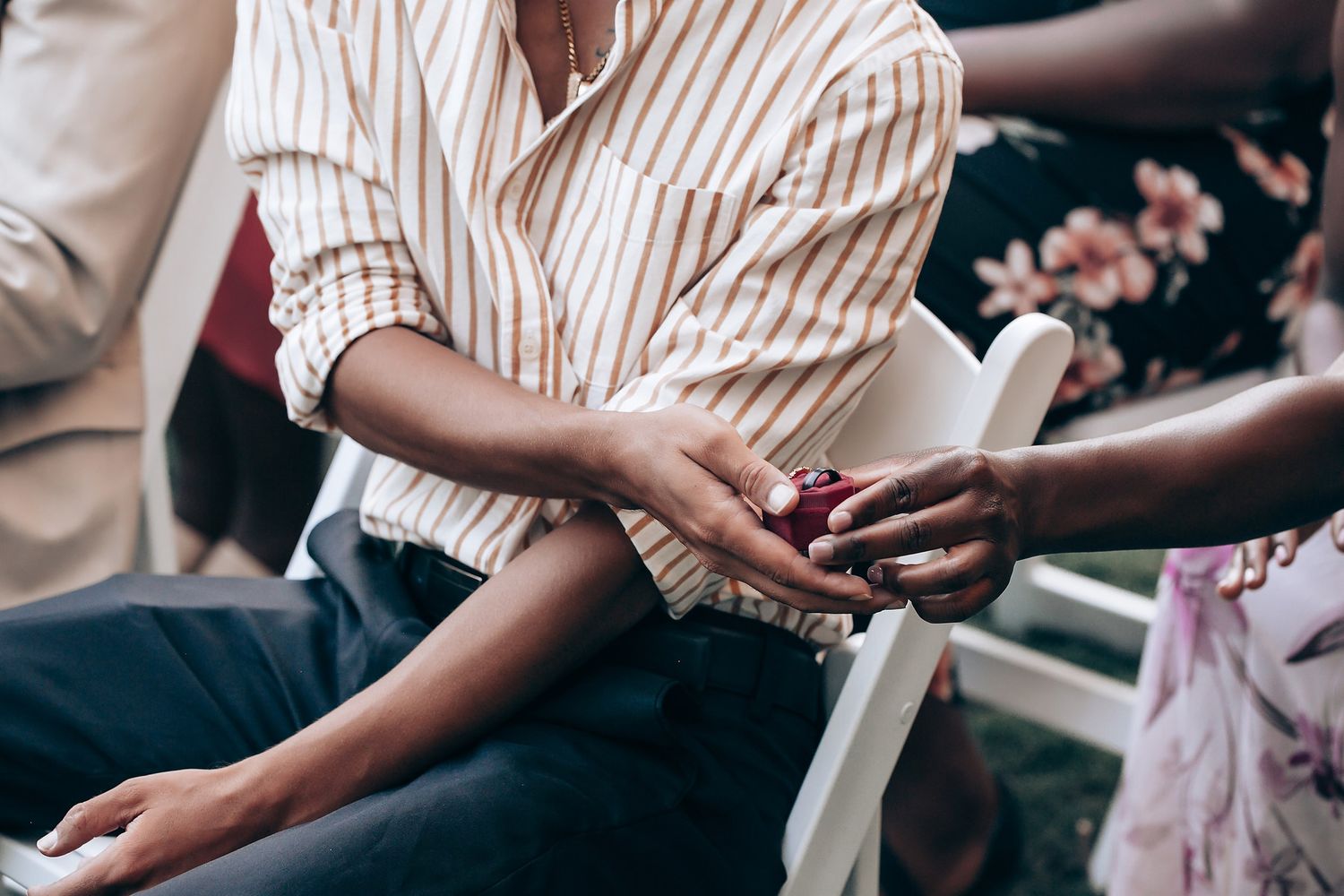 Close-up of hands exchanging money and paperwork during a business transaction.