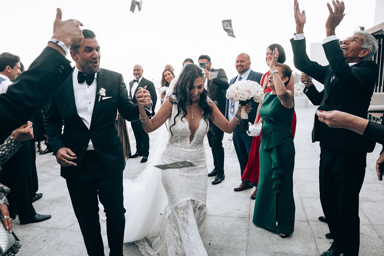 Wedding guests dancing and celebrating together in a joyful group moment.