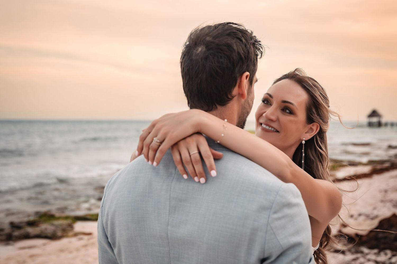 Intimate beach wedding portraits captured during golden hour.
