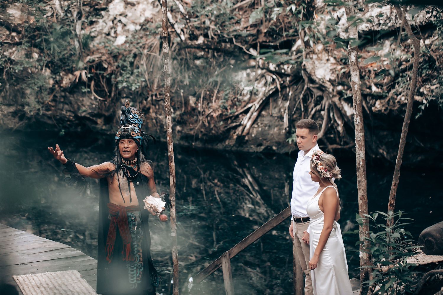 Intimate outdoor celebration setup in a natural cave setting.