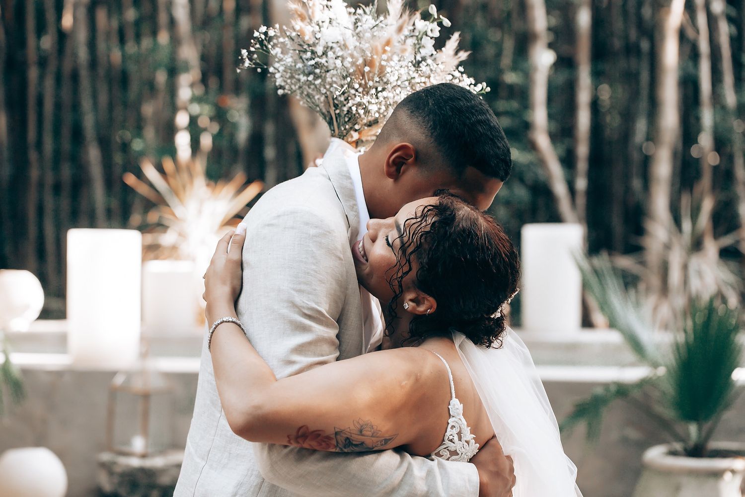 Intimate wedding moment captured in a forest setting with natural lighting.