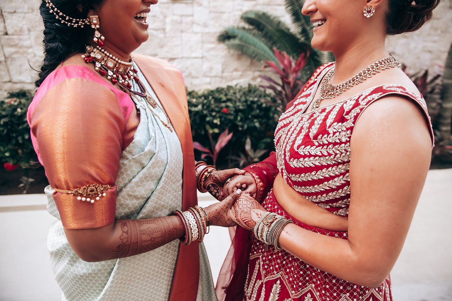 Wedding guests in red and white attire share joyful moments during a celebration.