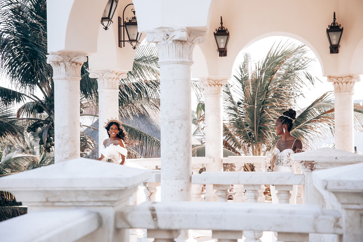 White columns and arches create an elegant Mediterranean backdrop for a wedding celebration.