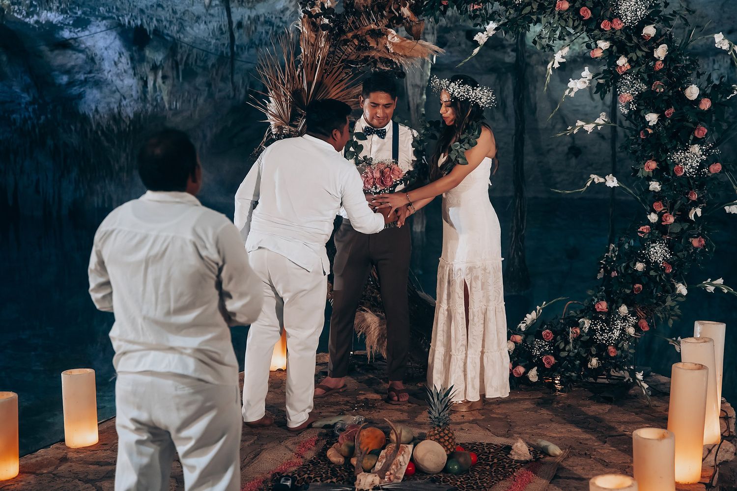 A wedding ceremony takes place at night with luminous paper lanterns and floral decorations creating a romantic atmosphere.