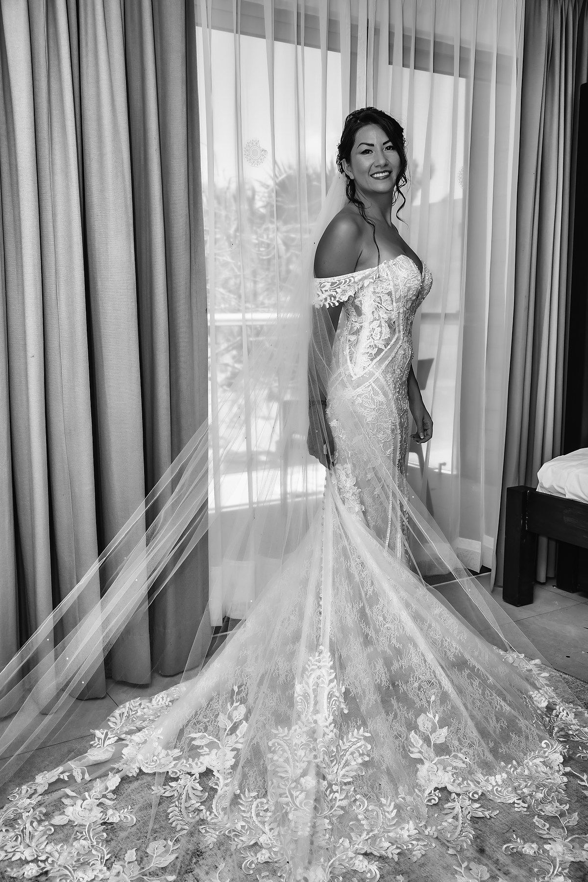 A sequence of elegant bridal portraits showcasing the flowing train of a lace wedding gown against sheer curtains.