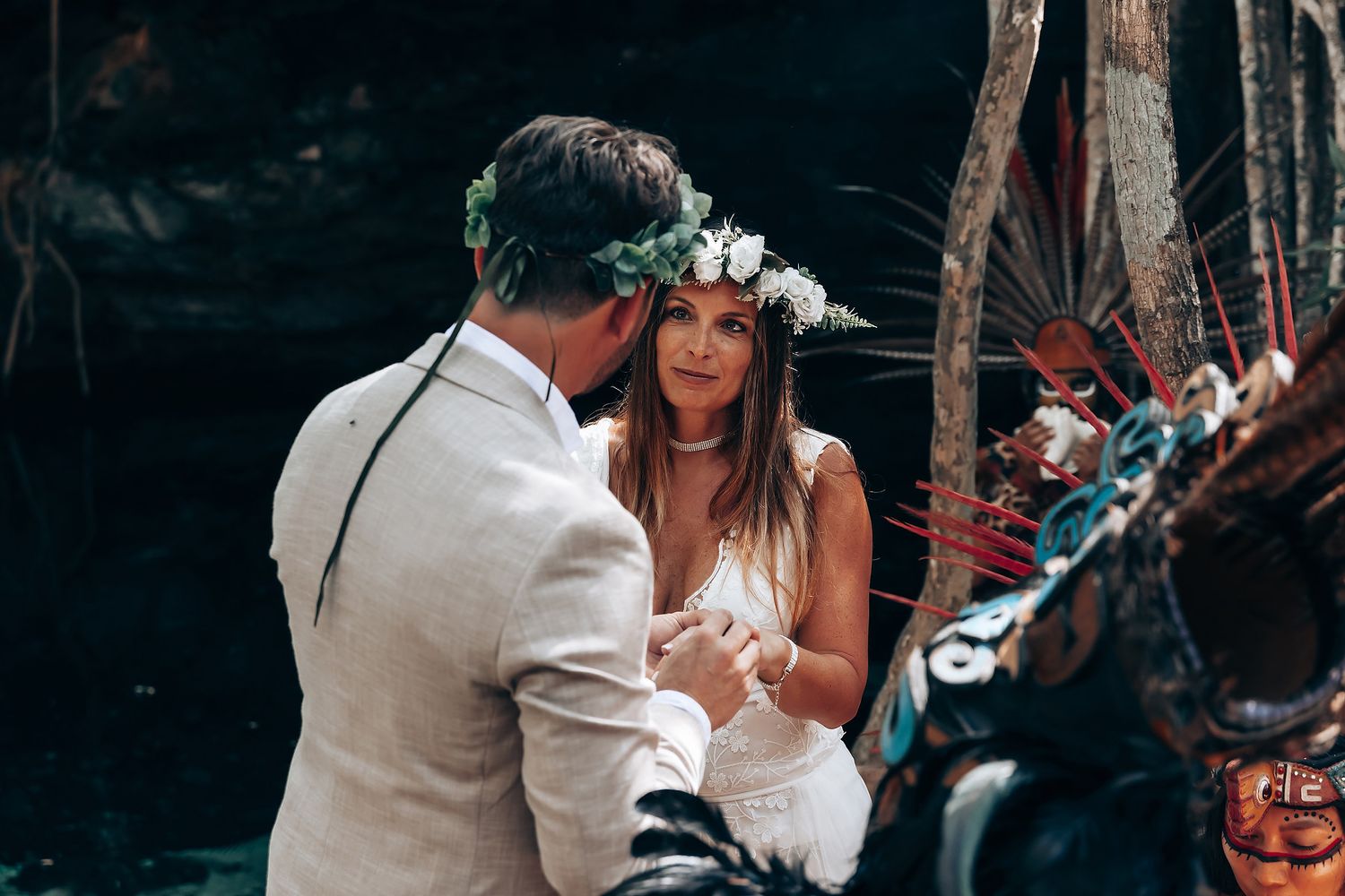 A romantic wedding ceremony takes place in a lush tropical garden setting with palm trees and natural decor.