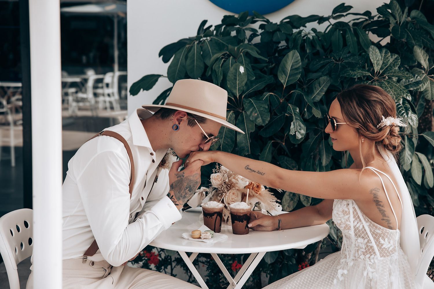 Wedding guests enjoying a celebration at a tropical outdoor venue.
