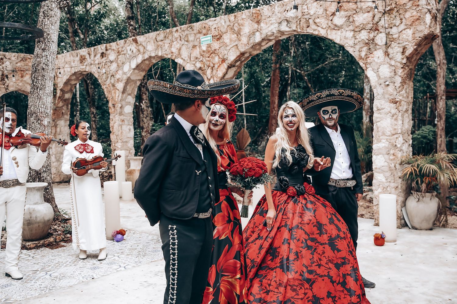 Wedding celebration with Mexican Day of the Dead theme featuring traditional decorations and costumes.