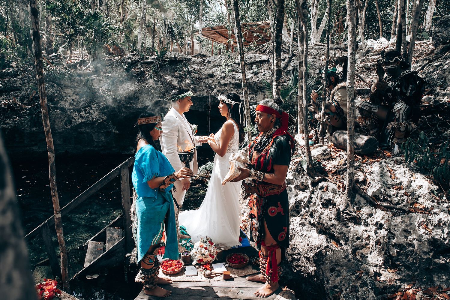 Wedding ceremony in progress showing traditional customs and rituals in a forest environment.