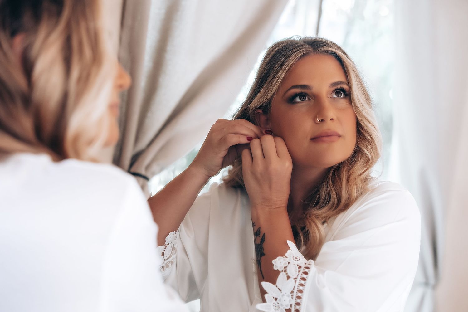 A woman in a white button-down shirt poses for a series of four professional portrait photographs.