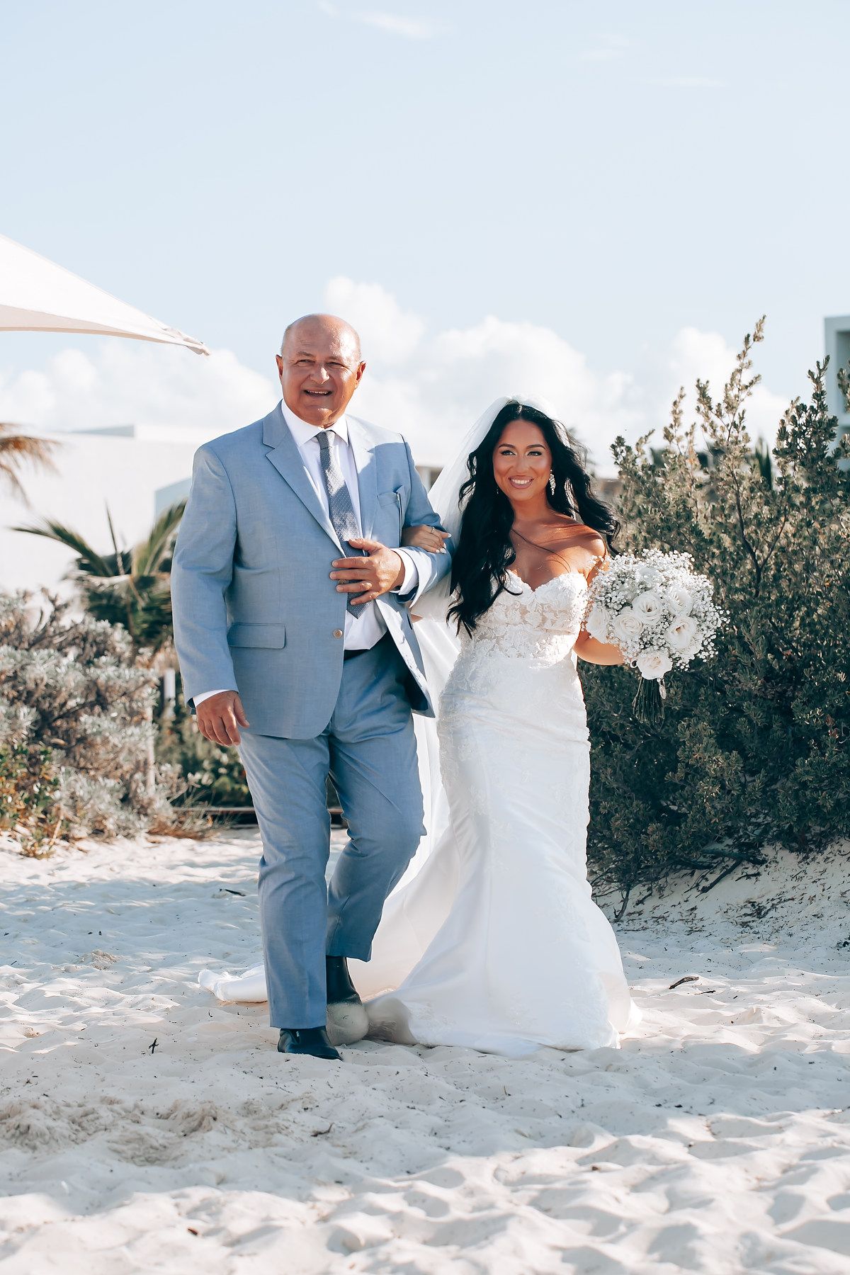 Bride and groom walking on the beach at Grand Palladium Costa Mujeres