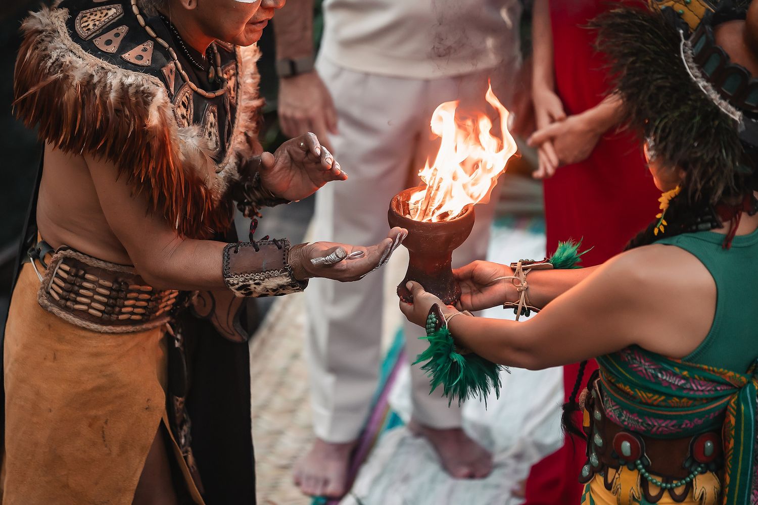 People dancing and celebrating at a lively party with sparklers and drinks in hand.