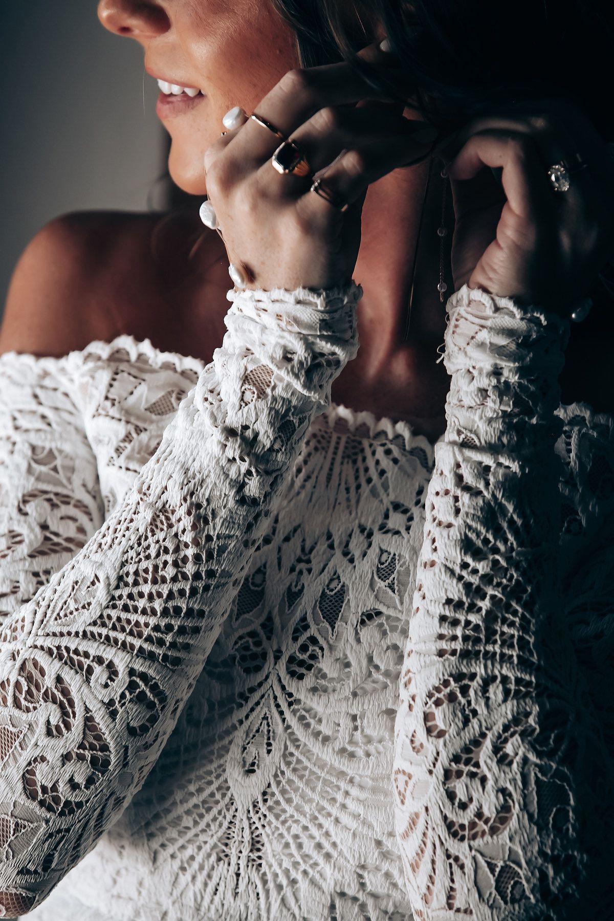 A sequence of close-up shots showing delicate white lace details on a wedding dress with intricate floral patterns.