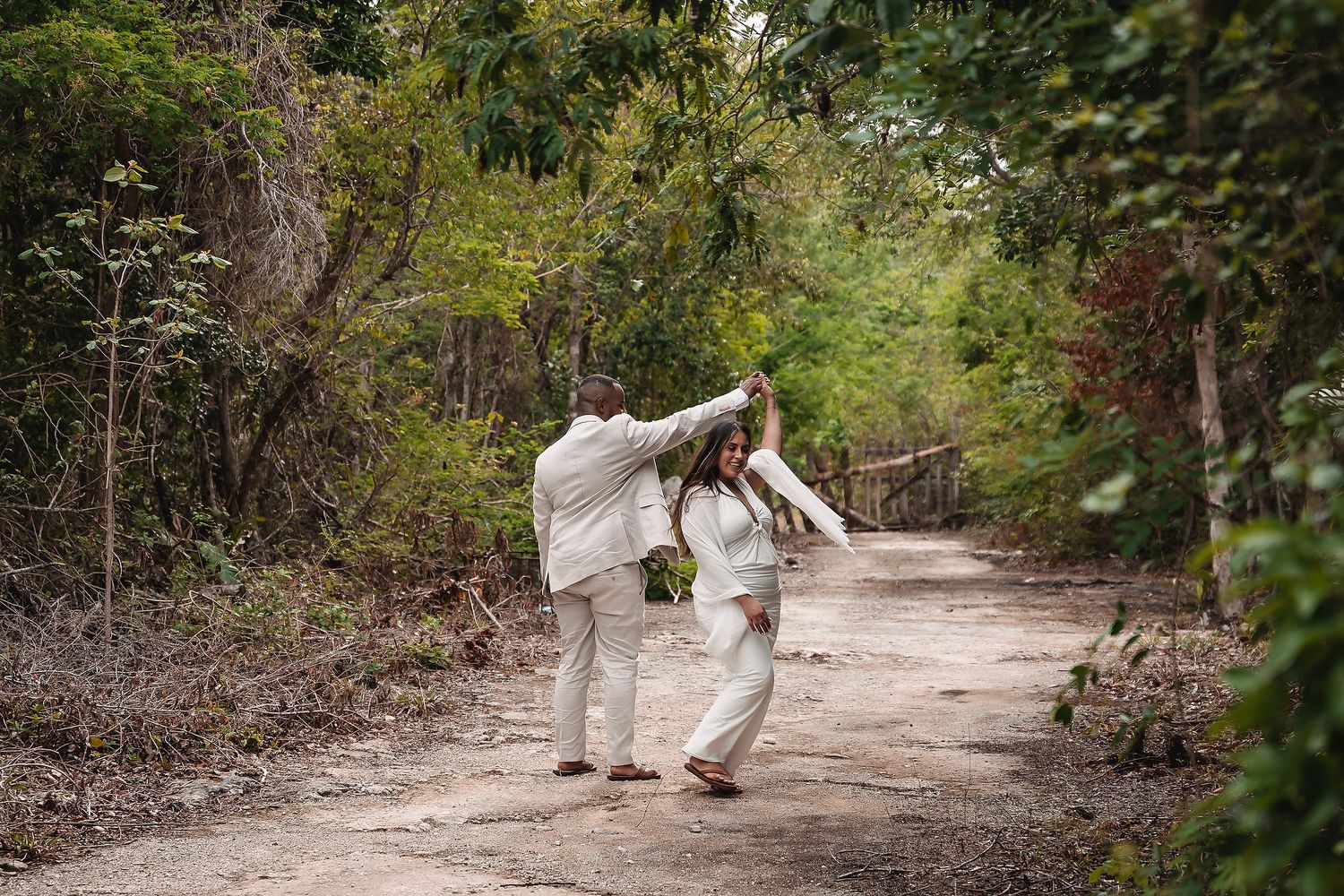 Romantic walk along natural jungle path in traditional white attire.