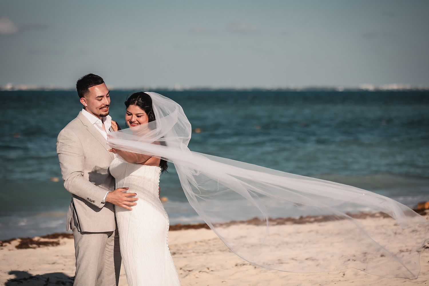 Joyful moments captured during a sunny beach wedding ceremony.