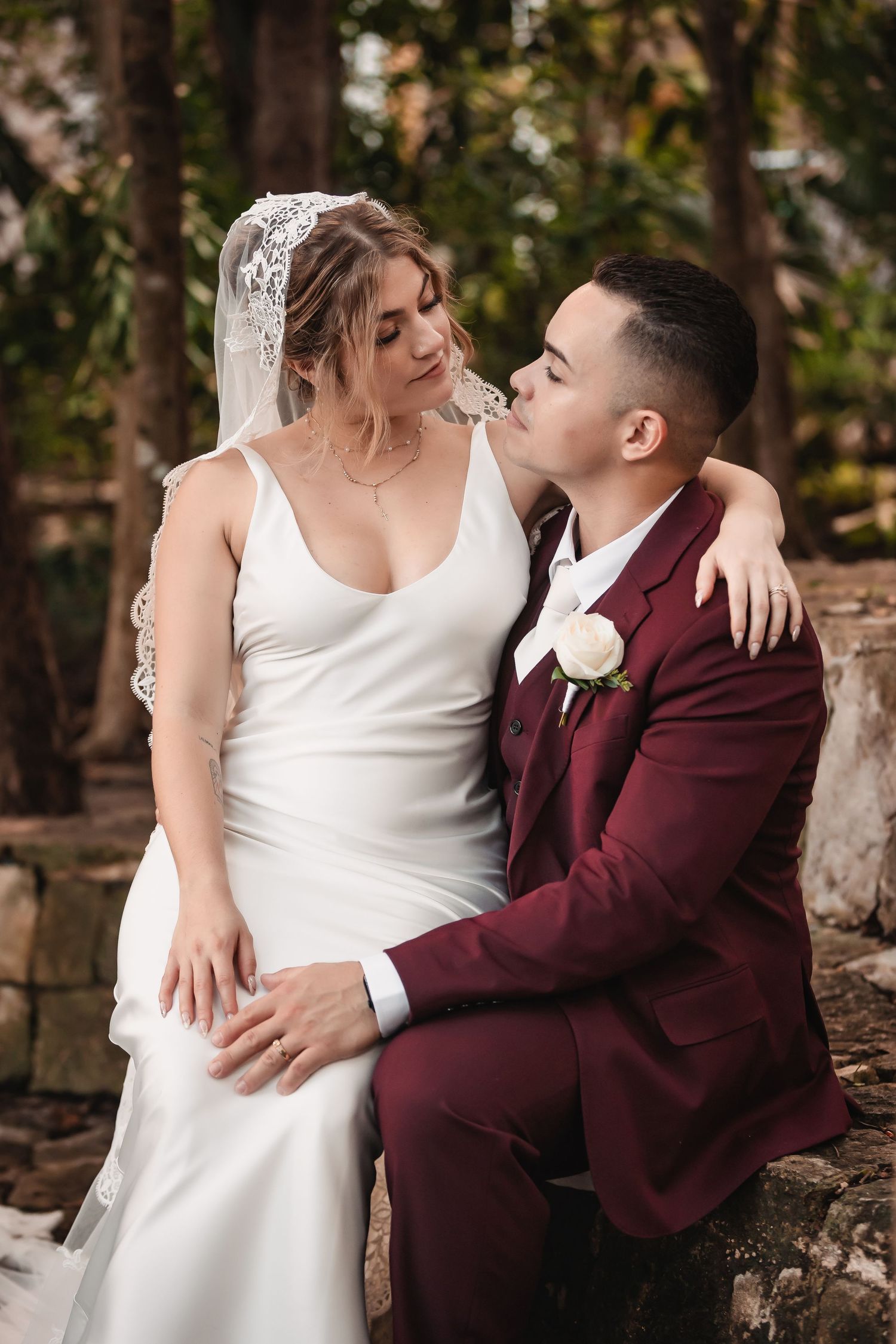 Intimate wedding portraits taken in natural outdoor setting with autumn foliage.