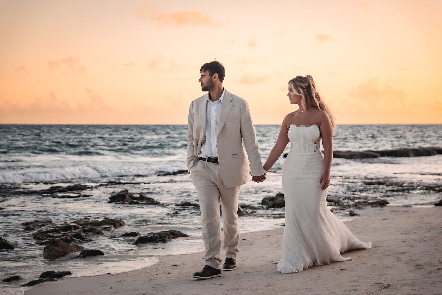 Wedding couple walking on the beach at Sandos Caracol Playa del Carmen