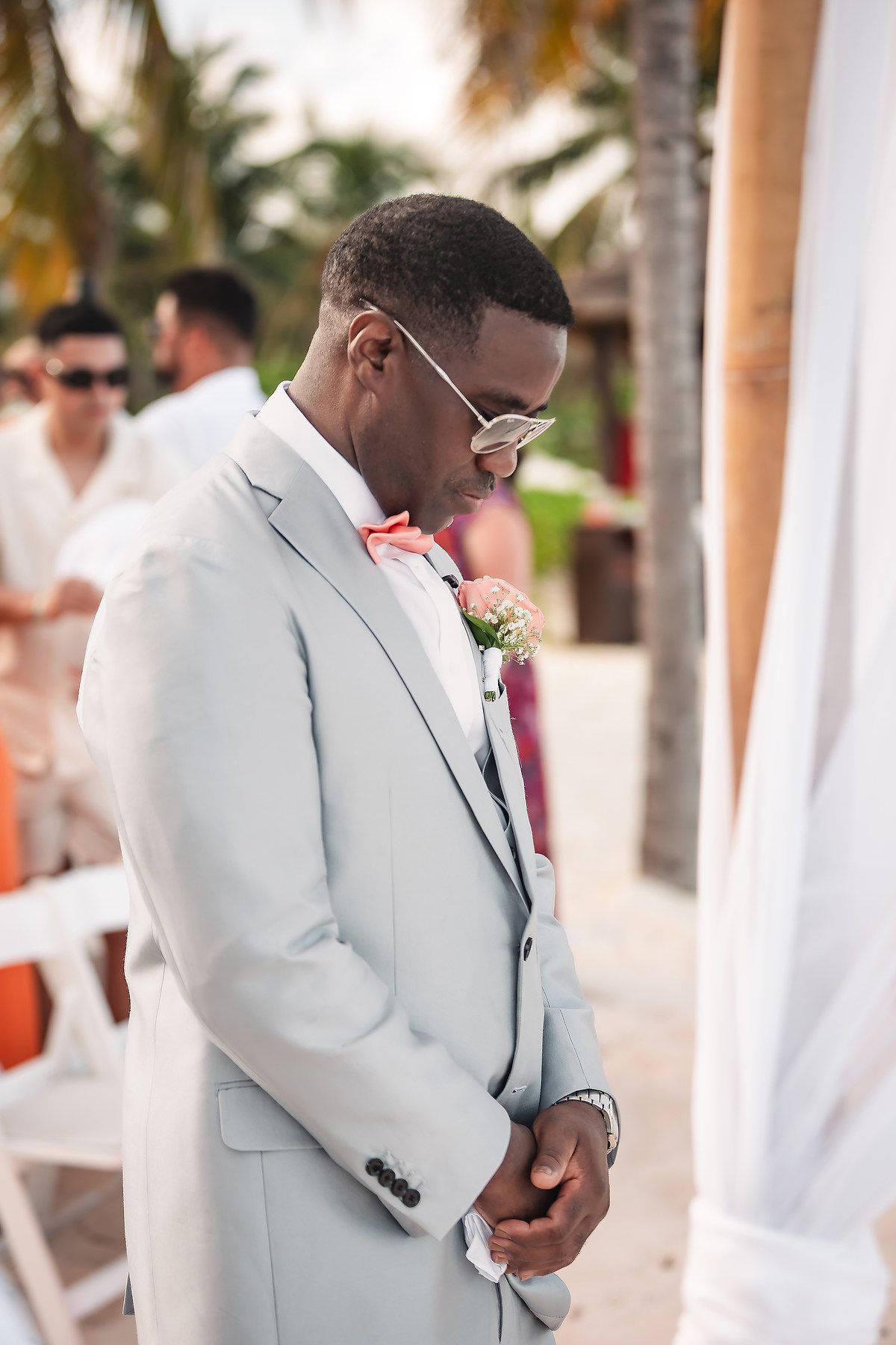 Wedding ceremony moments captured at a beachside venue with tropical palm trees.