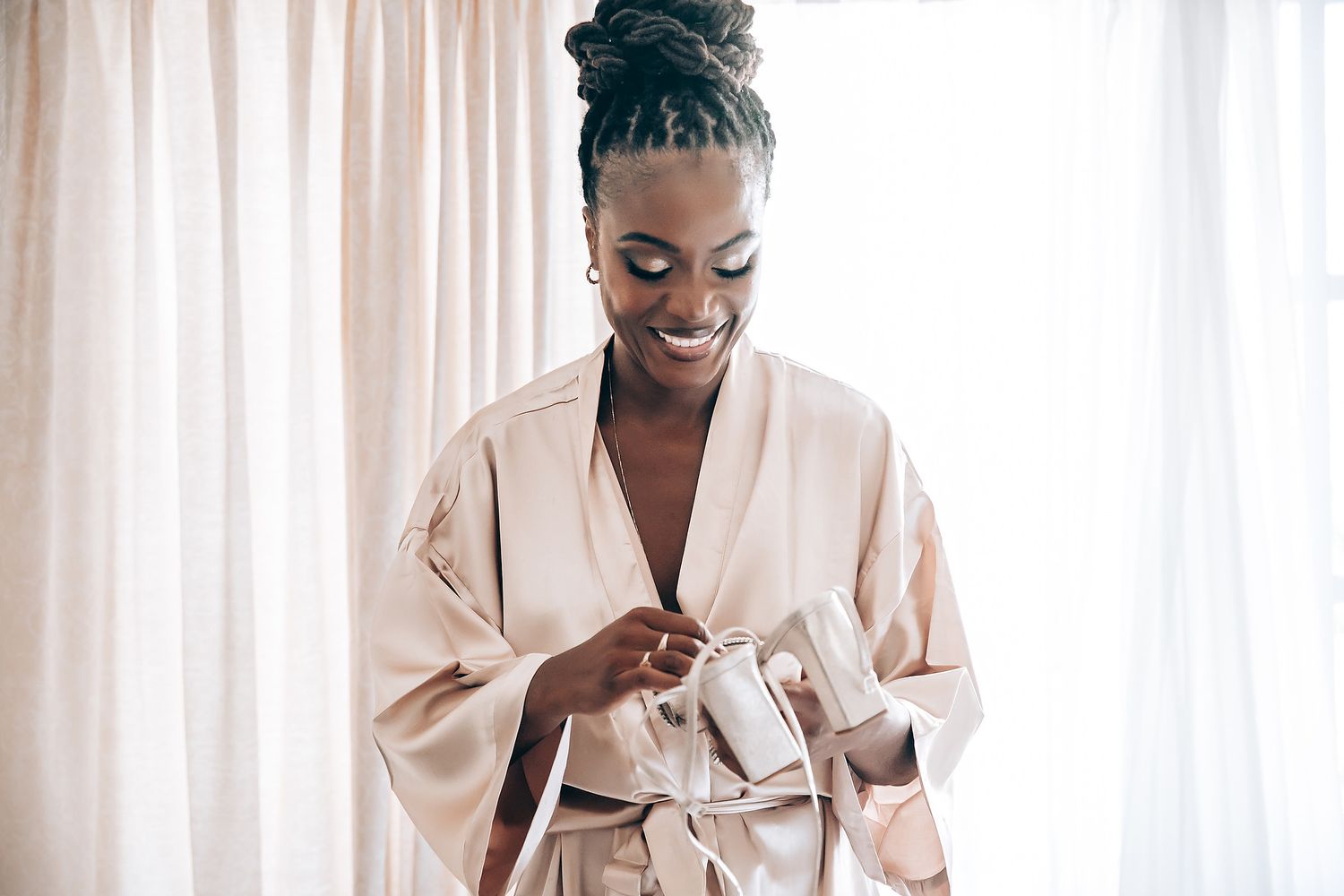 A person in a white robe preparing for a wedding ceremony at a tropical resort.