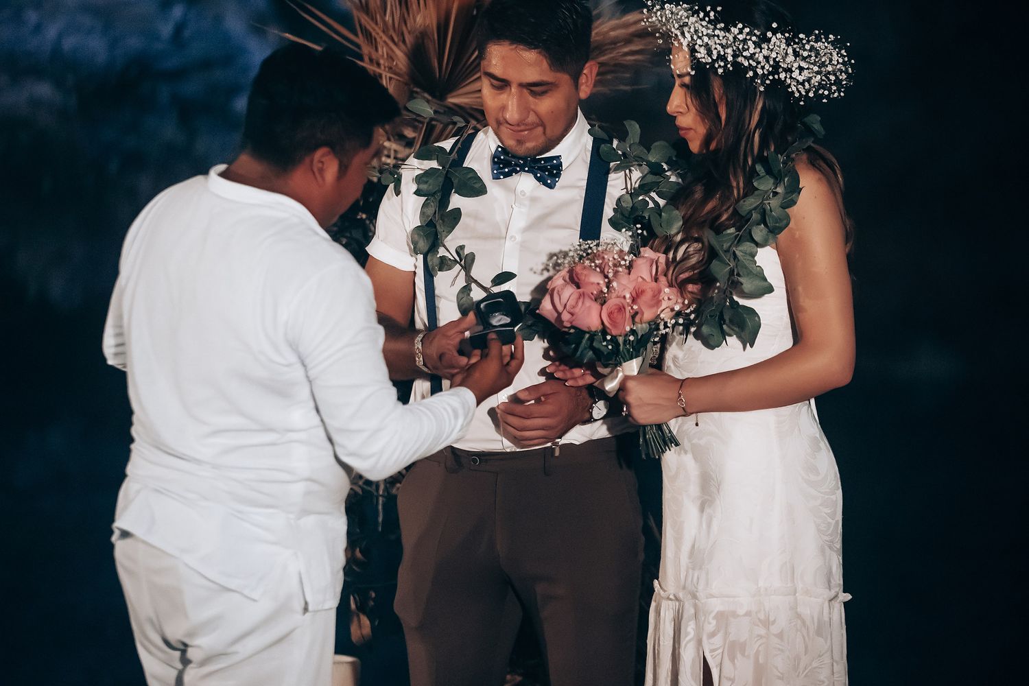 A wedding couple shares an intimate moment during their first dance at an elegant reception.