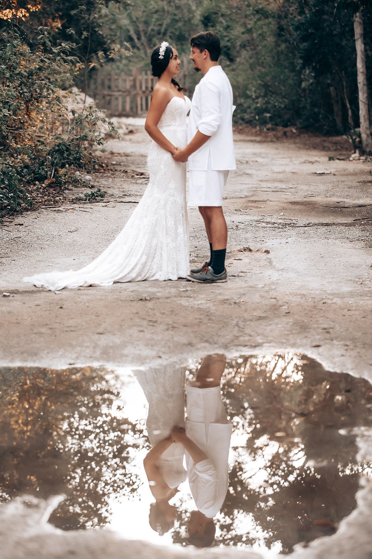 A romantic wedding photoshoot in a rustic outdoor setting with a flowing white dress and intimate poses between the couple.
