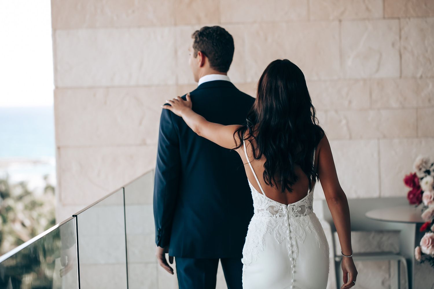 Intimate wedding ceremony moments captured against white walls and modern decor.