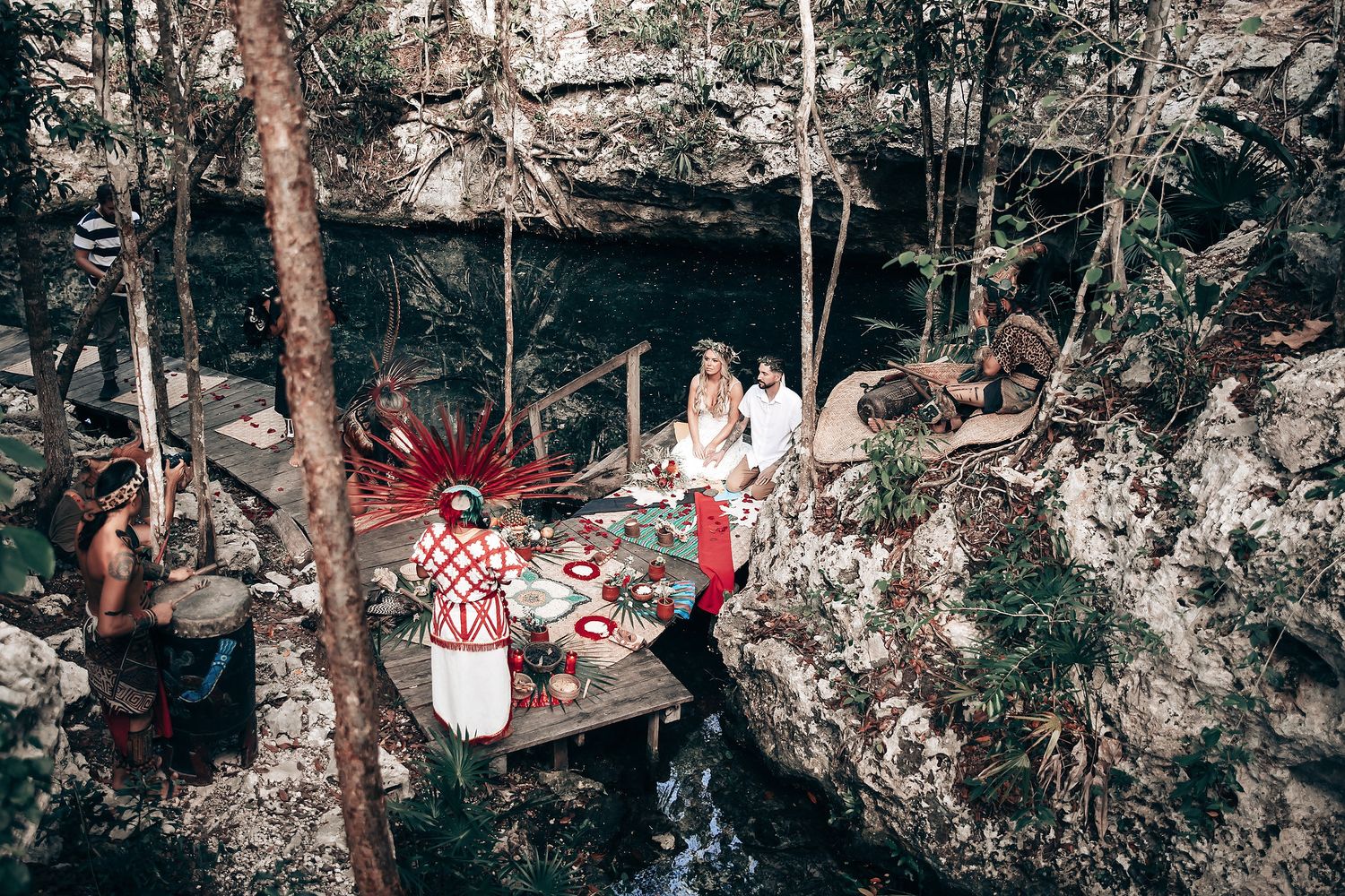 Forest setting with natural light filtering through trees during outdoor ceremony.
