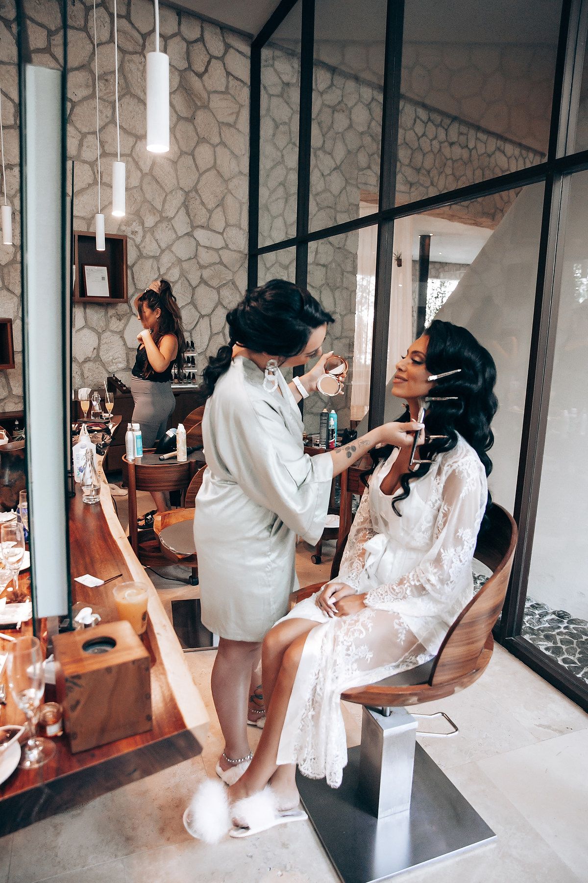 Wedding party getting ready in a modern room with hexagonal wall tiles and mirrors.