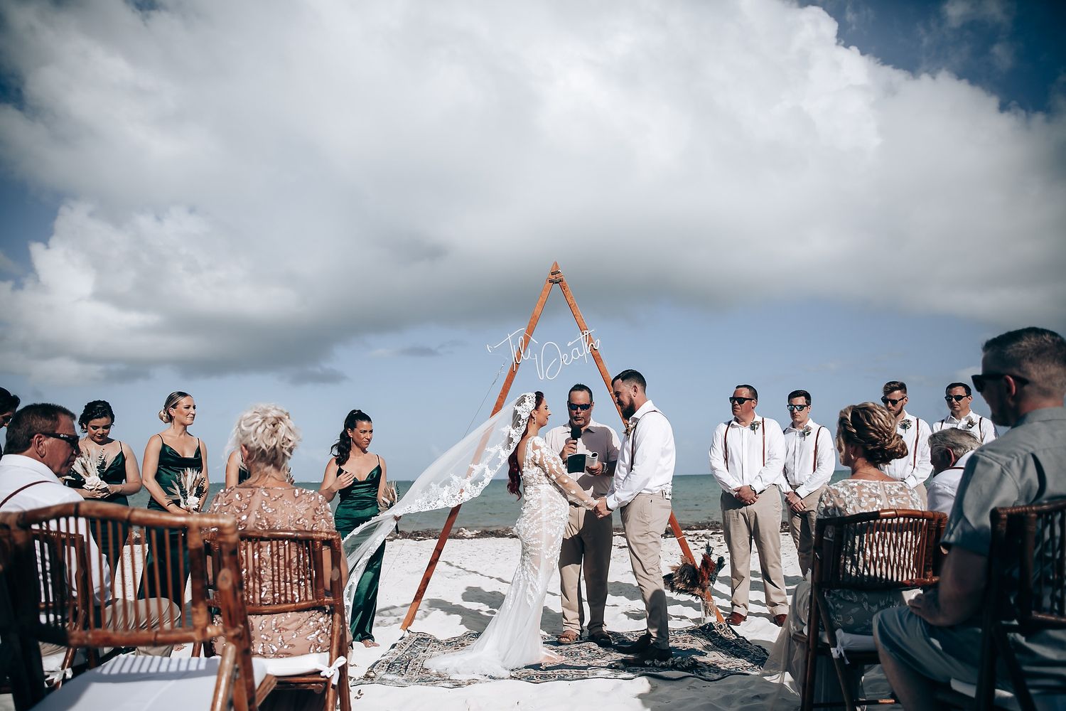 A panoramic sequence of outdoor wedding ceremony moments with guests gathered under cloudy skies.