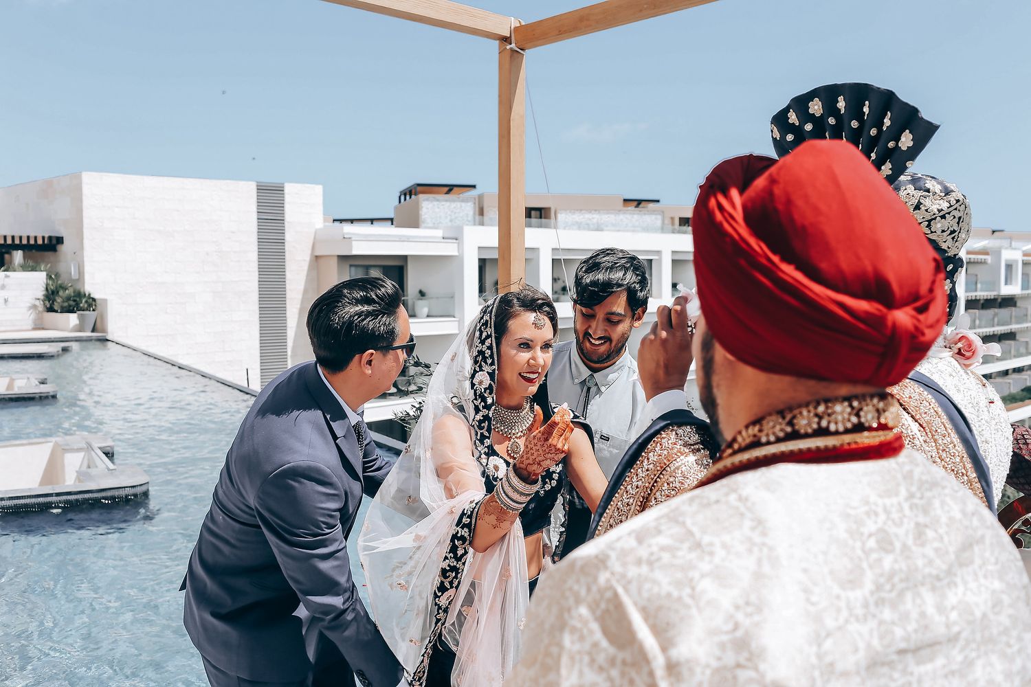 A series of candid wedding photos showing couples embracing and celebrating during an outdoor ceremony.