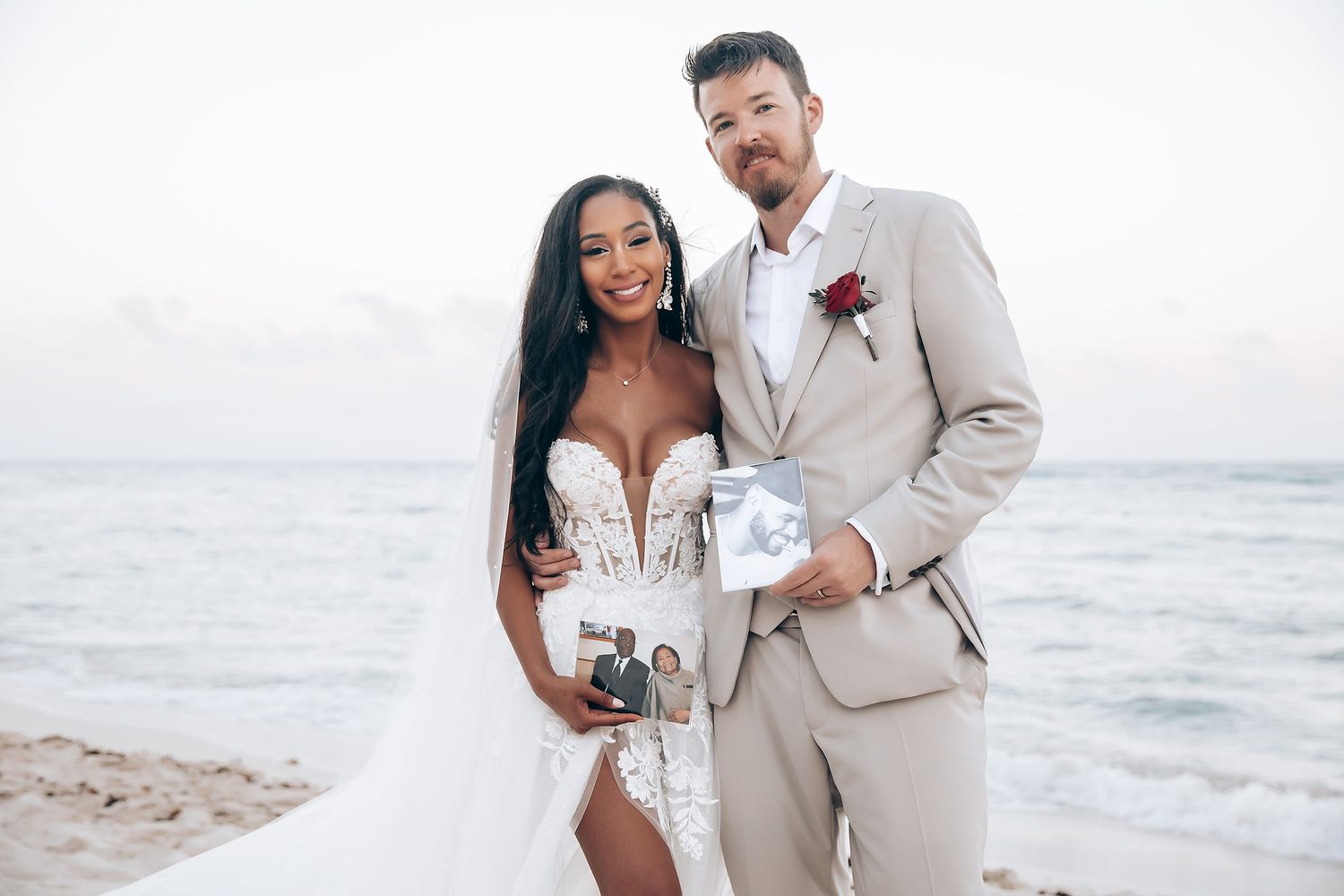 Romantic beachside wedding portraits with light colored attire against ocean backdrop.