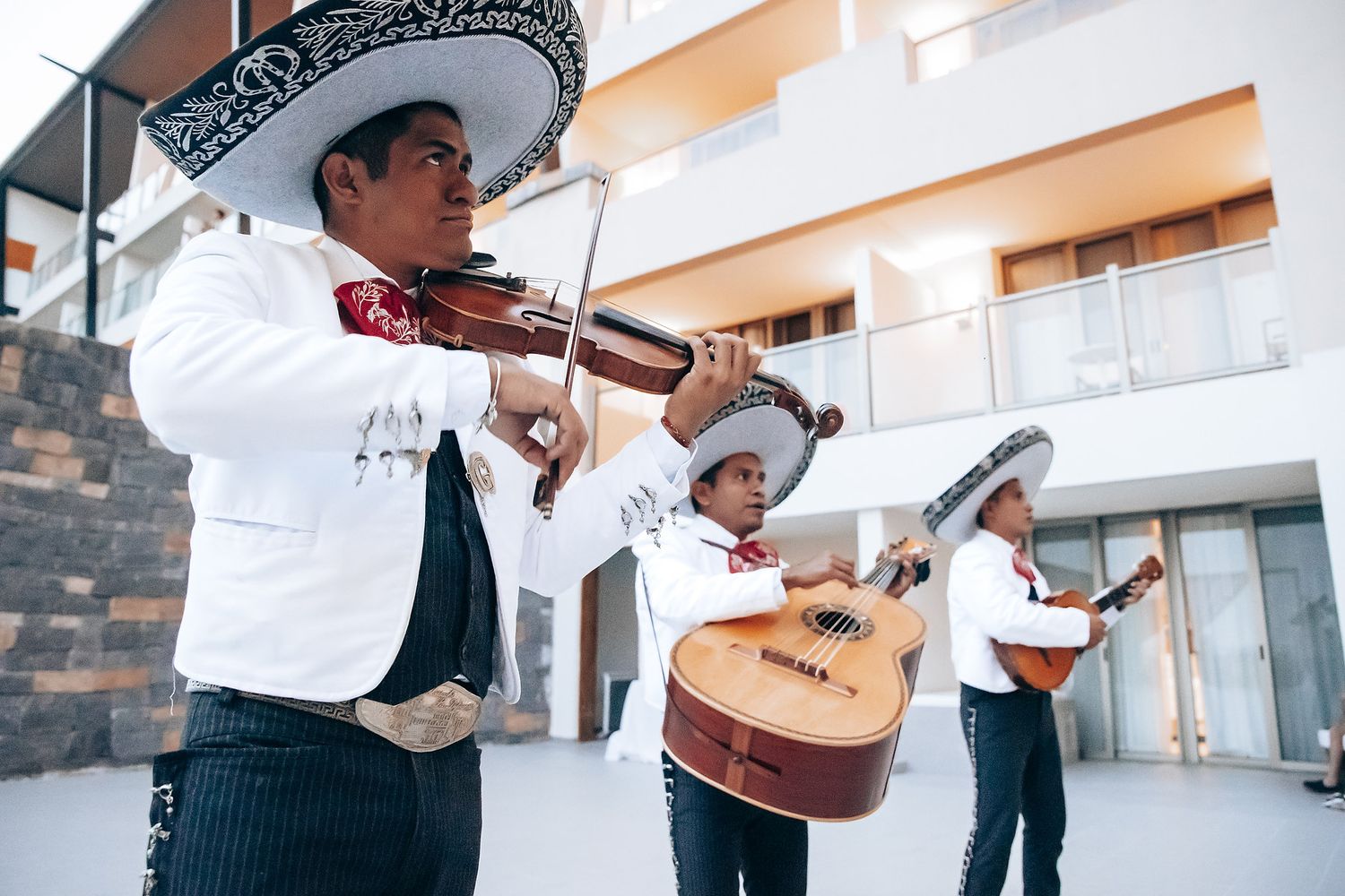 Musicians performing with guitars at an elegant indoor wedding celebration.