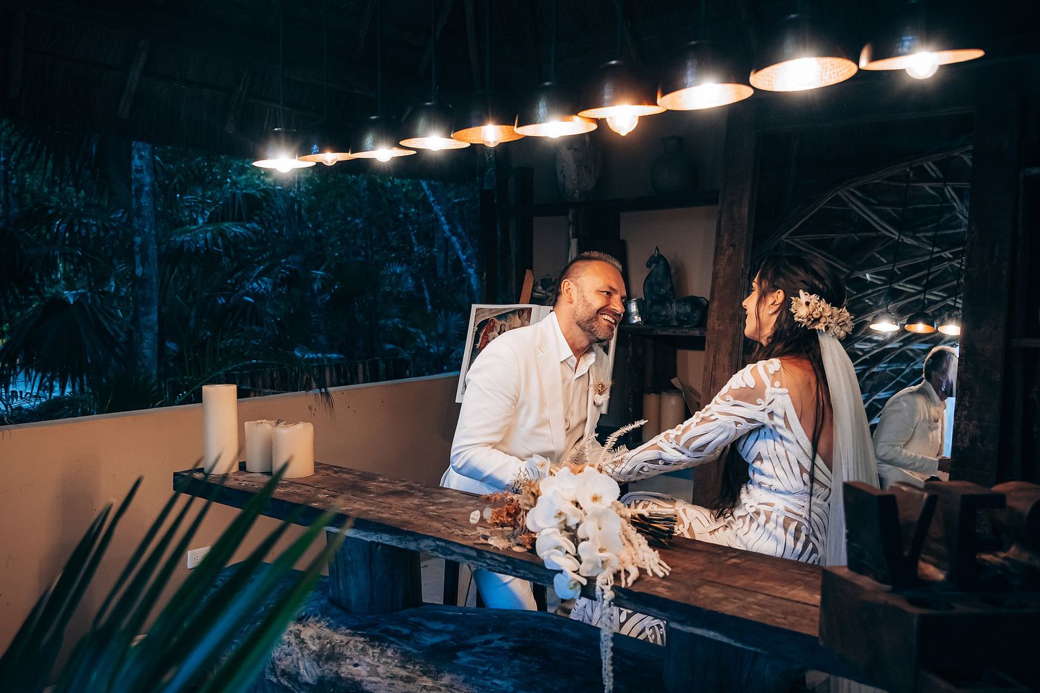 A romantic evening wedding reception with string lights illuminating the outdoor venue and dance floor.
