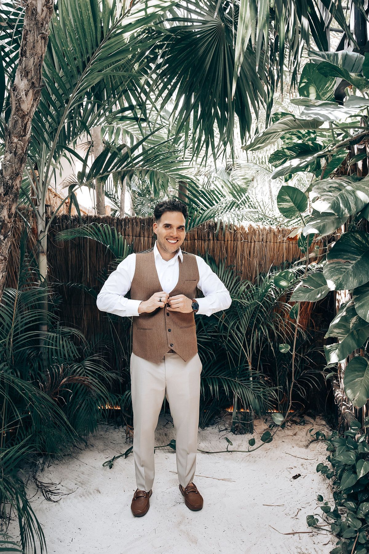 Wedding attire displayed in a lush tropical garden setting.