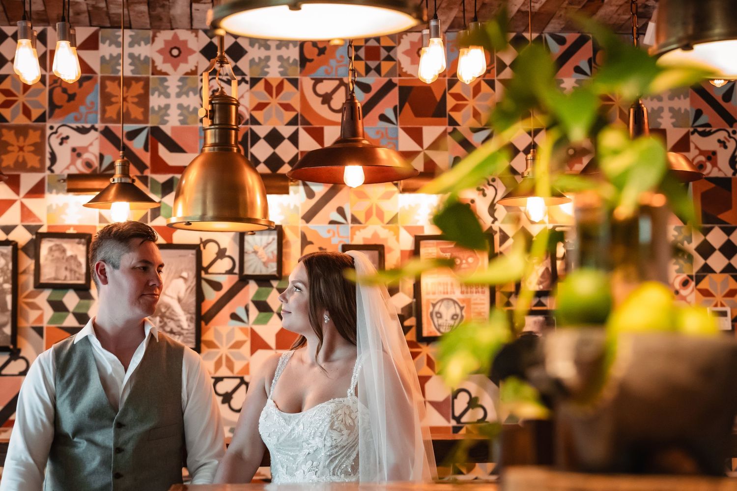 Wedding venue features warm lighting, exposed brick walls and decorative tile patterns.