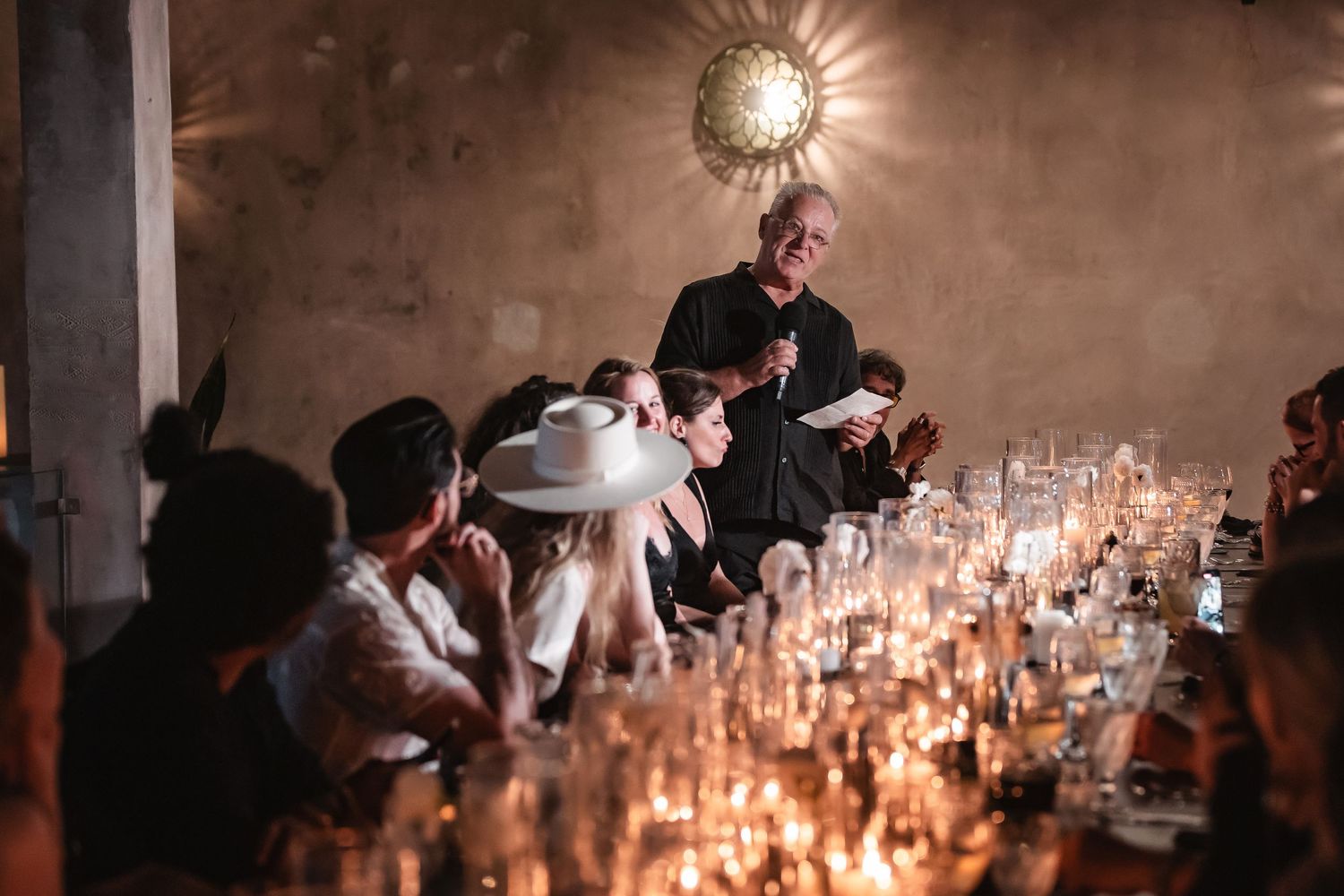 Candlelit reception tables create a romantic ambiance with glowing centerpieces and decorative lighting.