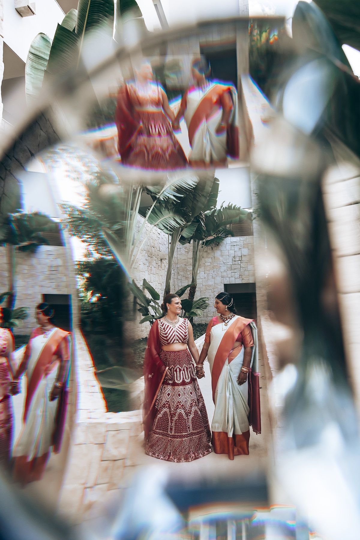 Artistic wedding photos captured through palm fronds creating a dreamy effect.