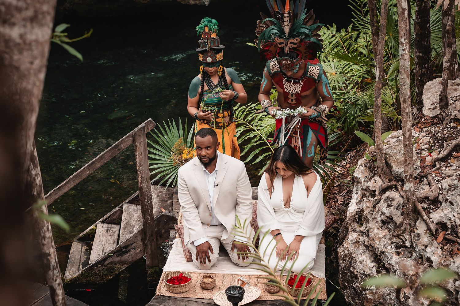 Intimate ceremony setup with traditional Mayan elements at a natural cenote location.