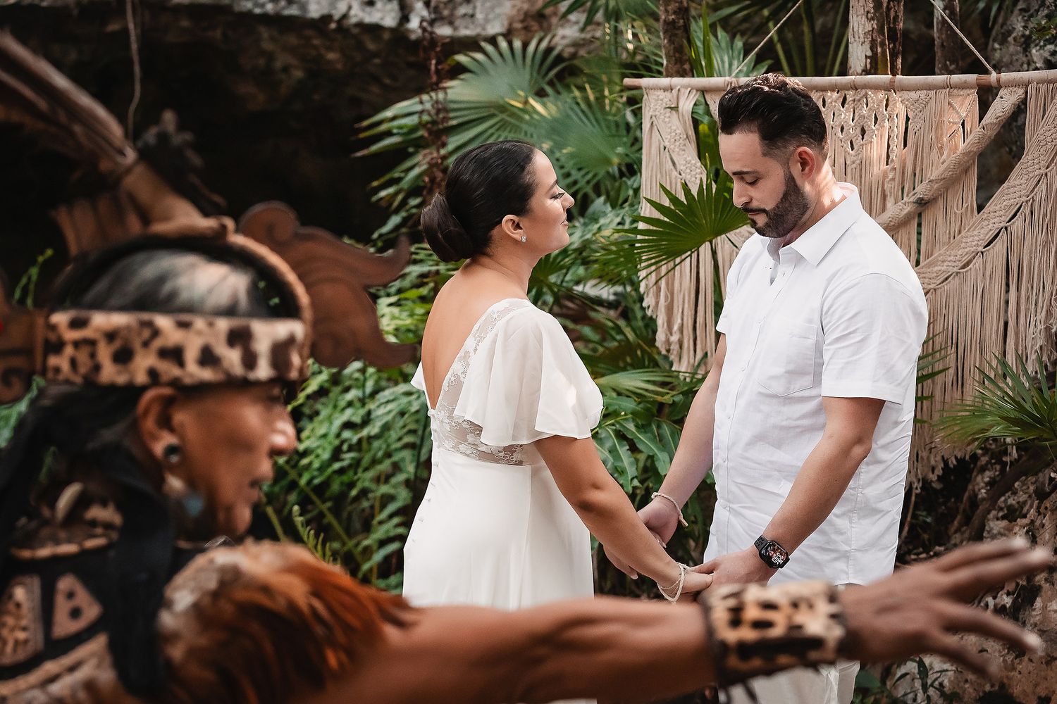 Traditional Mayan wedding ceremony being performed in a lush tropical garden setting.
