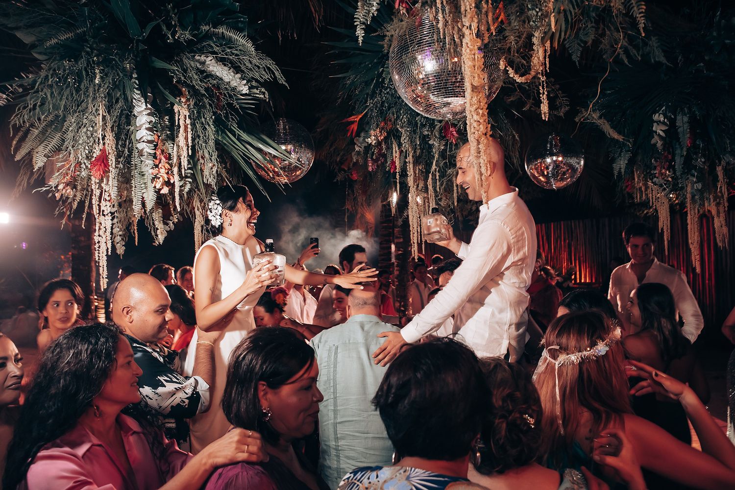 Energetic nightclub scene with dancers and party lights creating vibrant atmosphere.