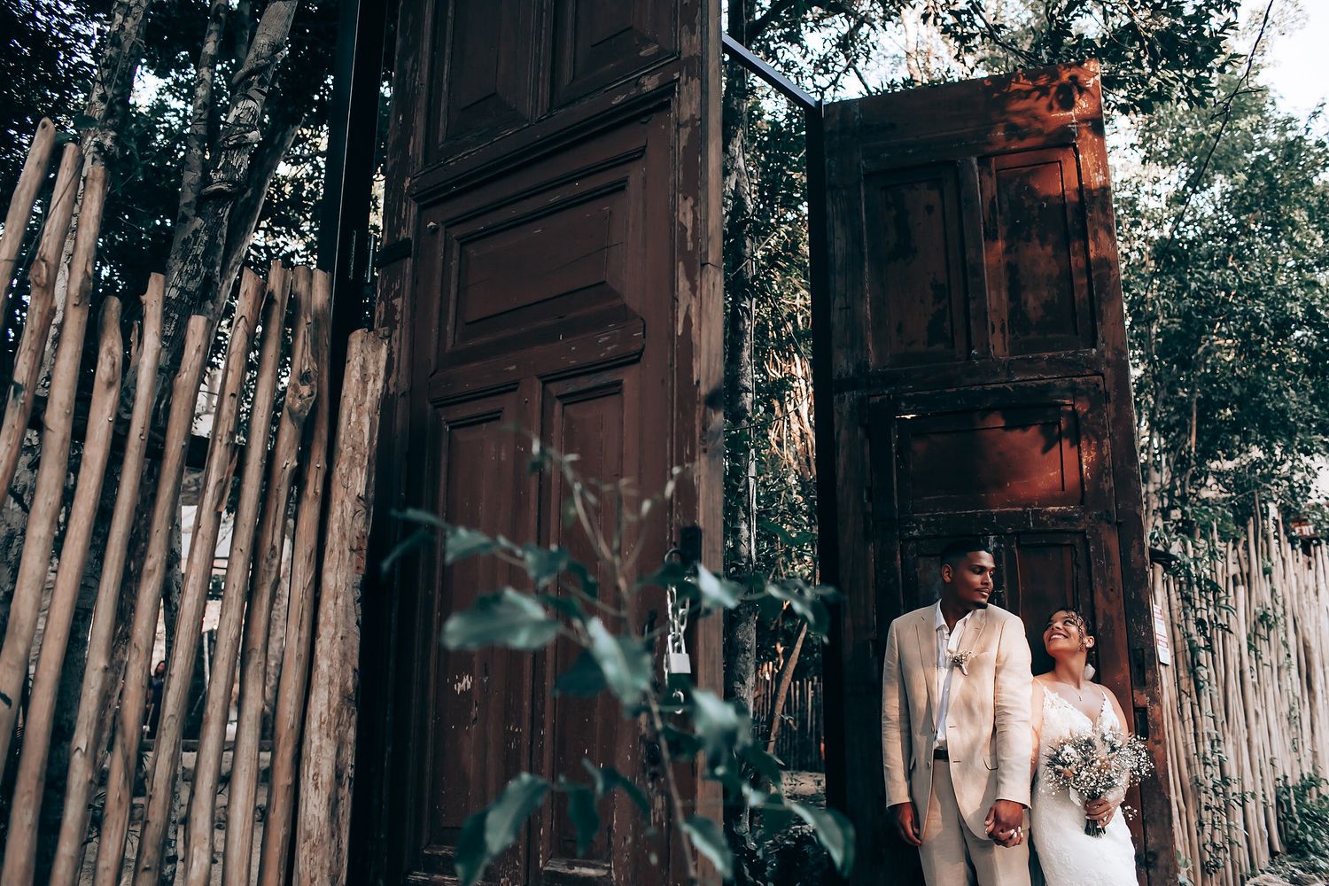 Outdoor wedding venue decorated with wooden elements and natural lighting.
