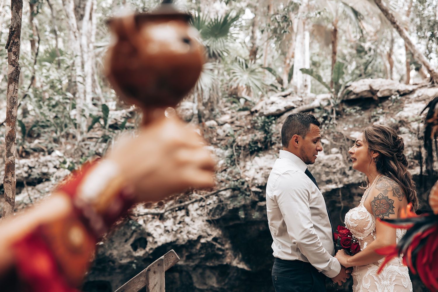Wedding celebration in a lush outdoor setting with natural greenery and decorative elements.