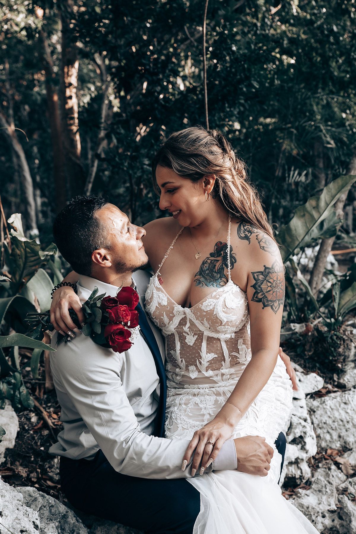 Intimate romantic moment captured against a natural rock formation backdrop.