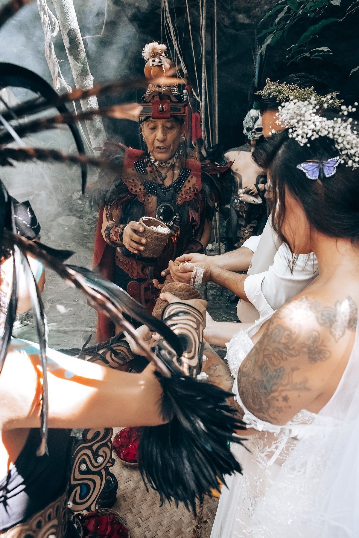 Traditional ceremony with smoke and feathers in an atmospheric outdoor setting.