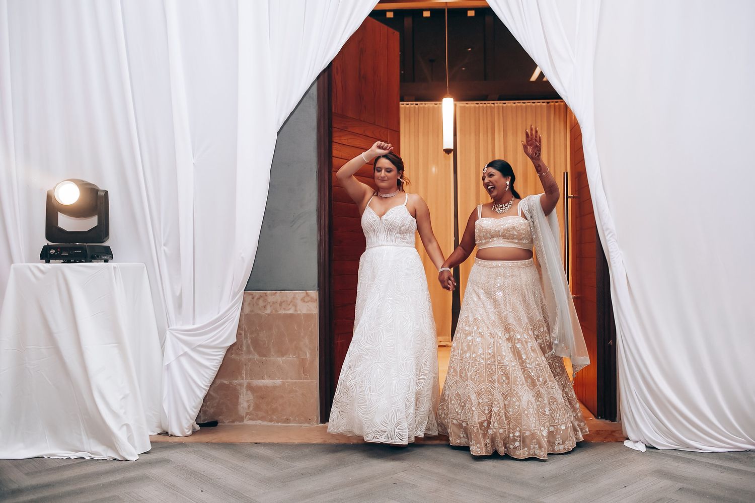 White fabric drapes creating an elegant backdrop for an indoor event space.