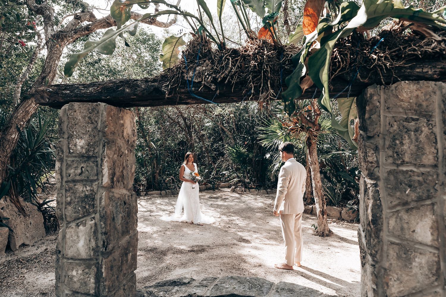 Stone pathway through jungle leading to ancient Mayan ruins during wedding ceremony.